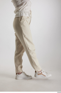 Yeva  1 beige pants casual dressed flexing leg side…